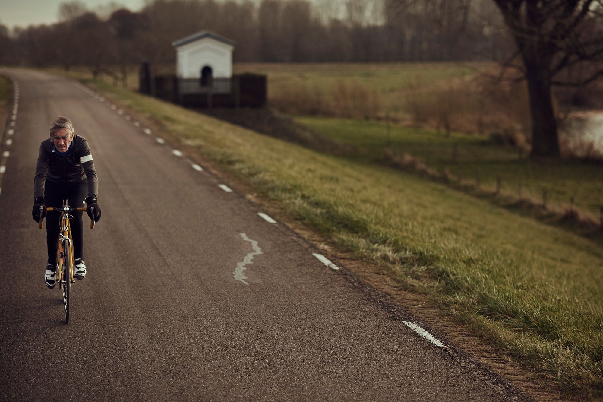 Albert cycling on an empty rural road