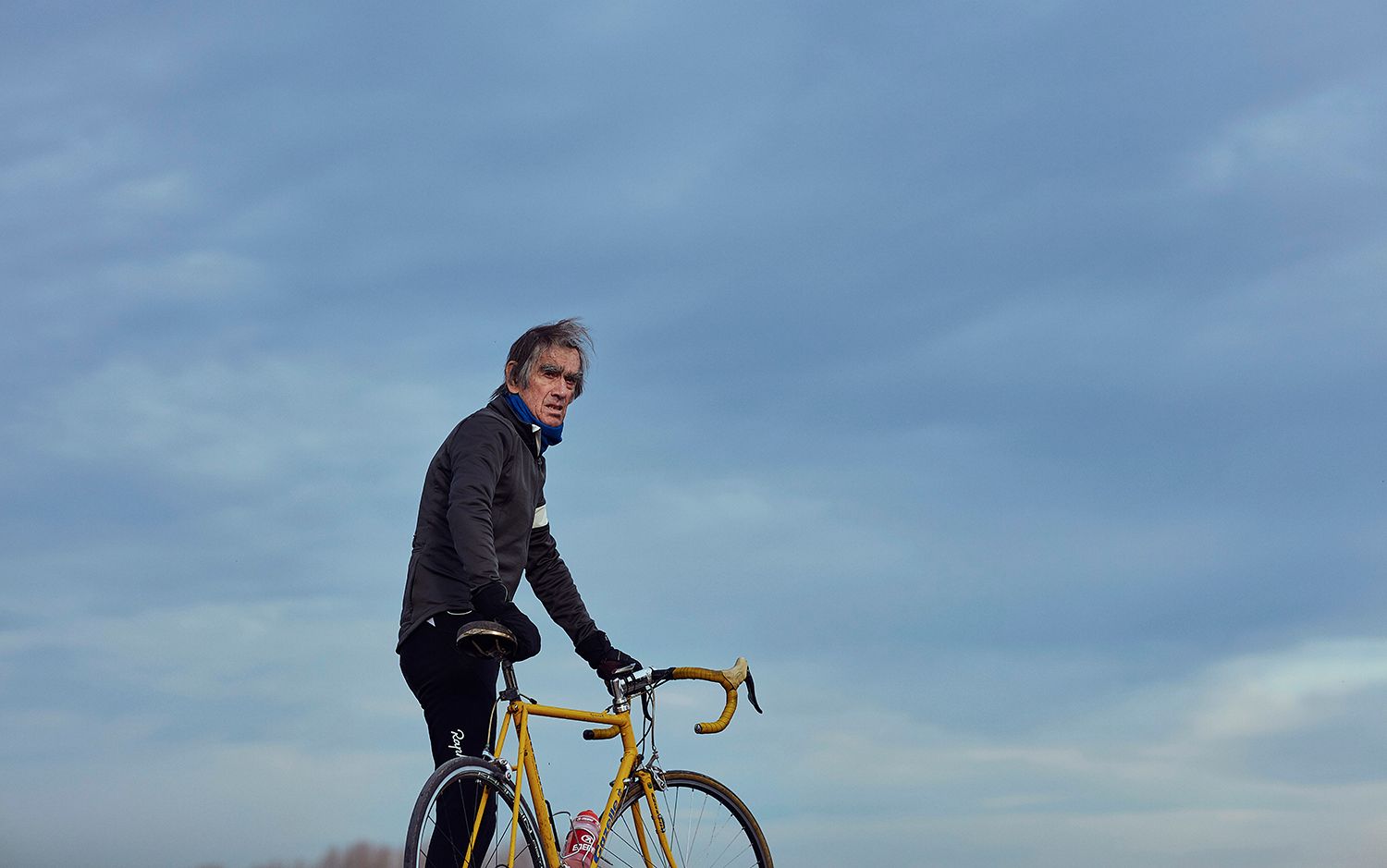 Albert standing beside his yellow steel Gazelle