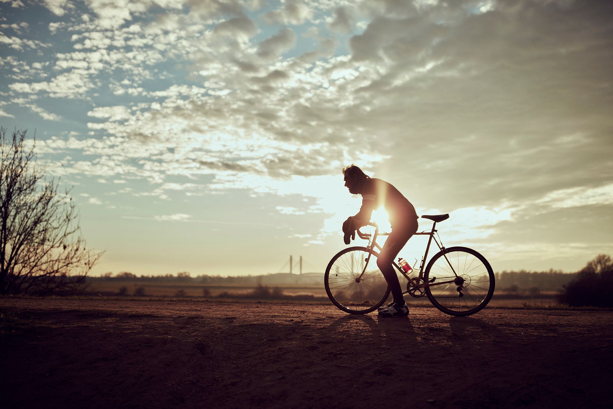 Albert and his bicycle silhouetted against a low winter sun