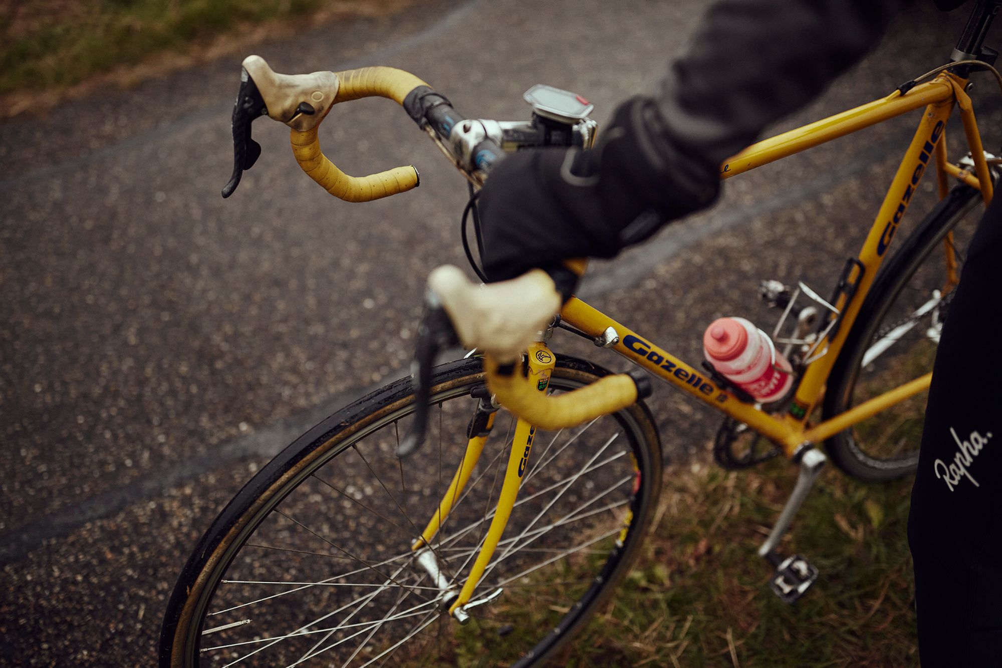 Albert’s hands and the yellow Gazelle bicycle viewed from above