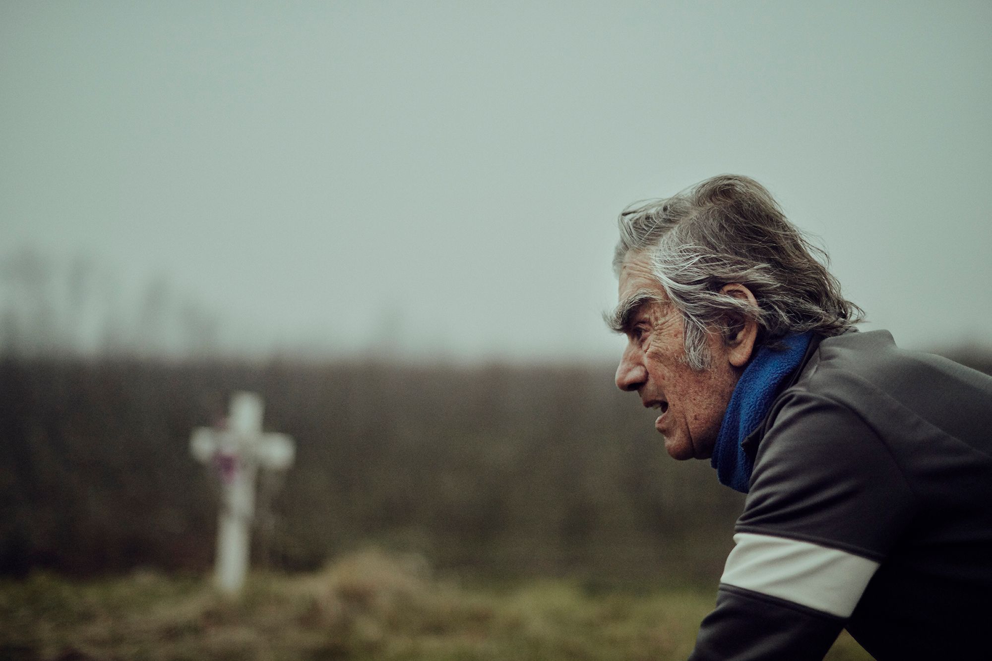 Albert riding past a roadside memorial cross