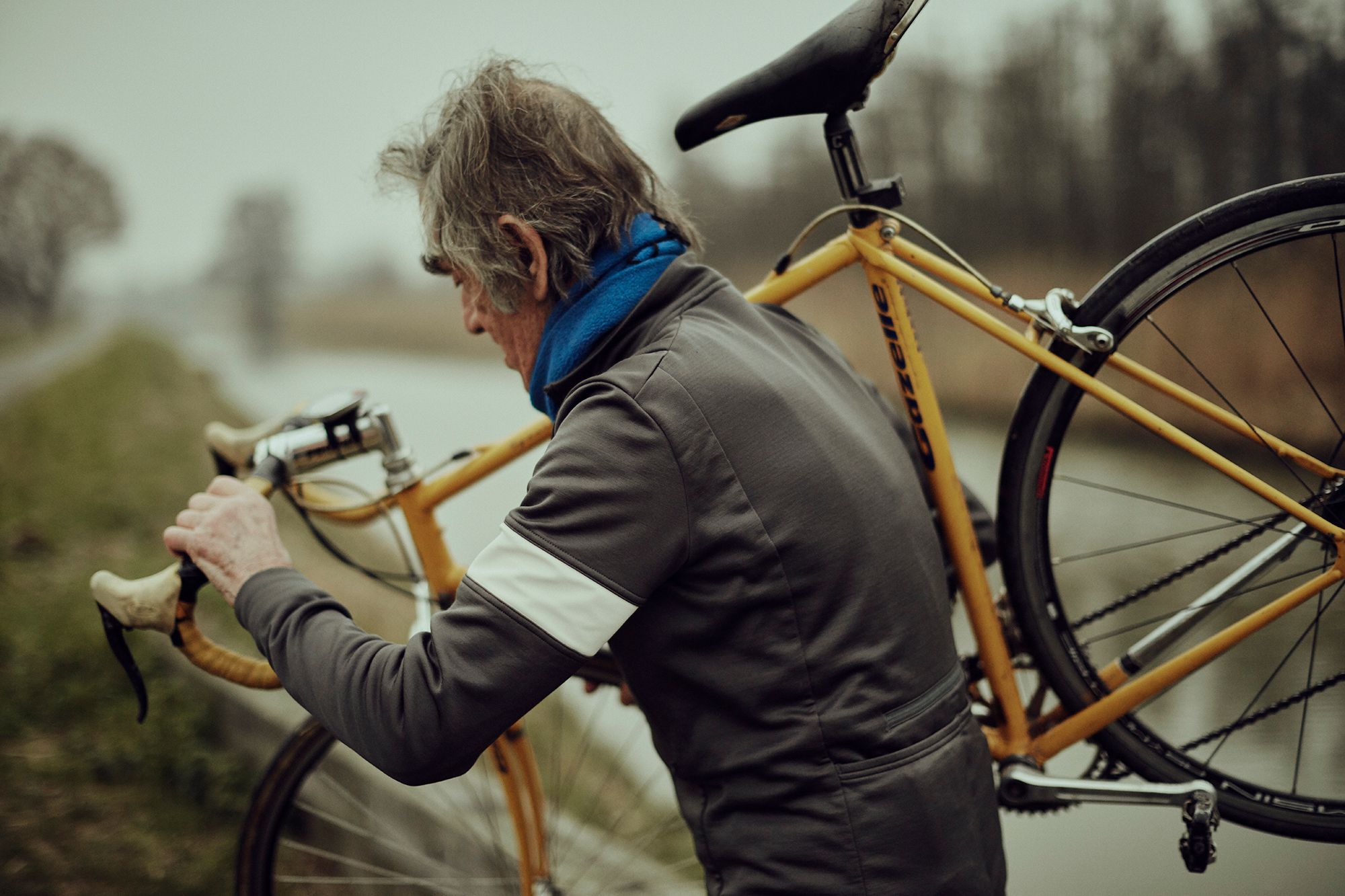 Albert carrying his yellow Gazelle bicycle