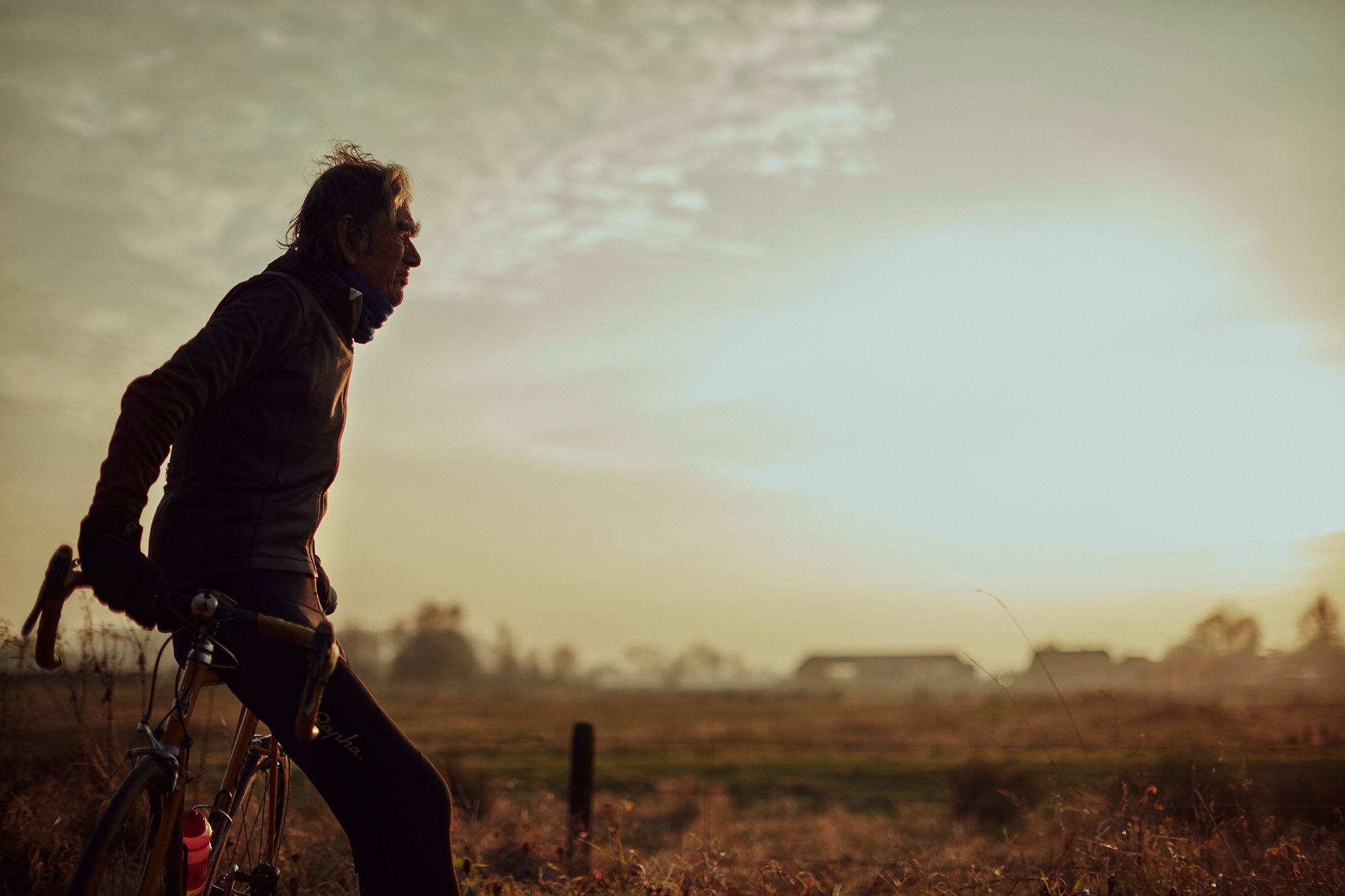 Albert standing with his bicycle in the evening light