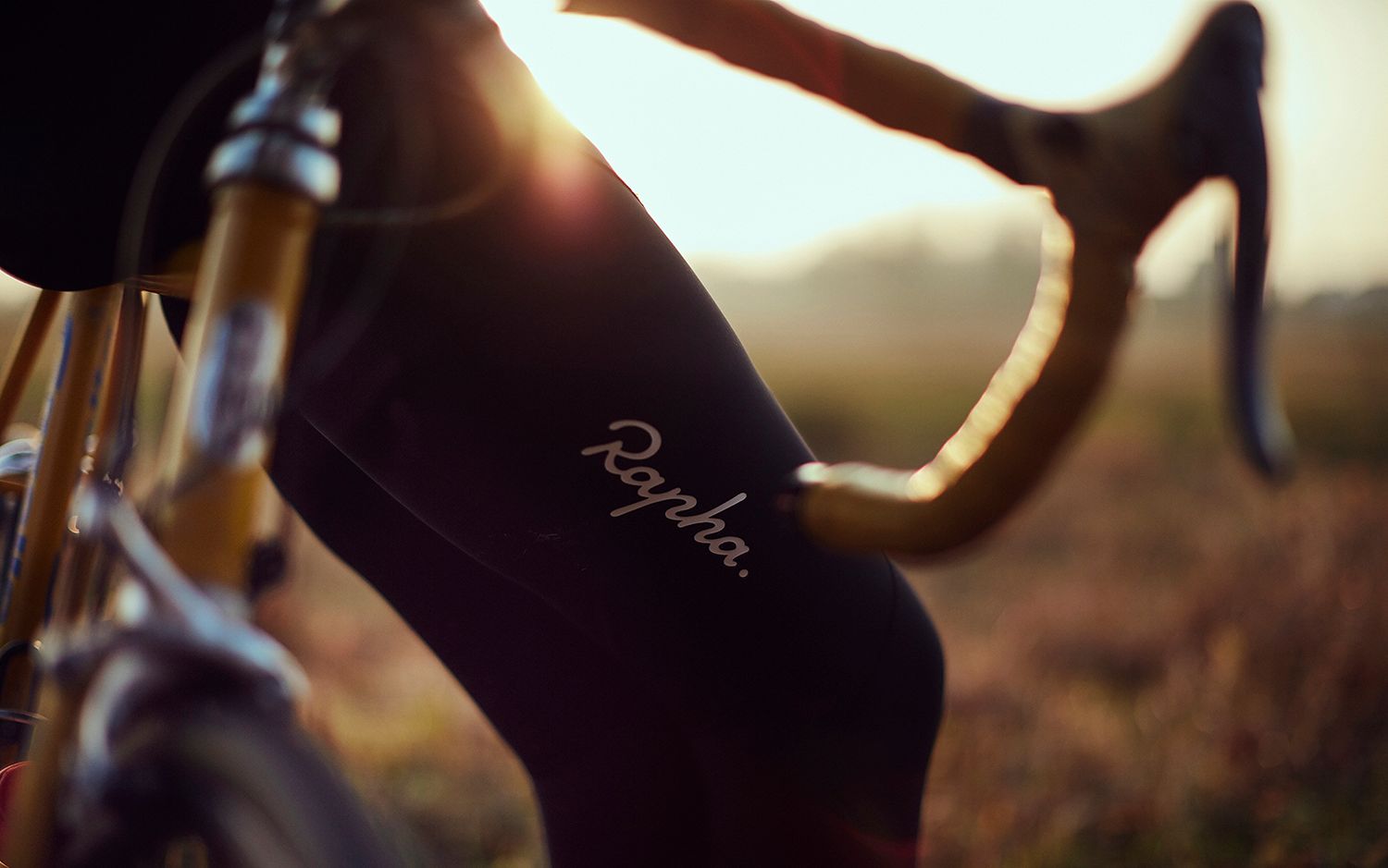 Albert’s Rapha tights beside the handlebars in evening light
