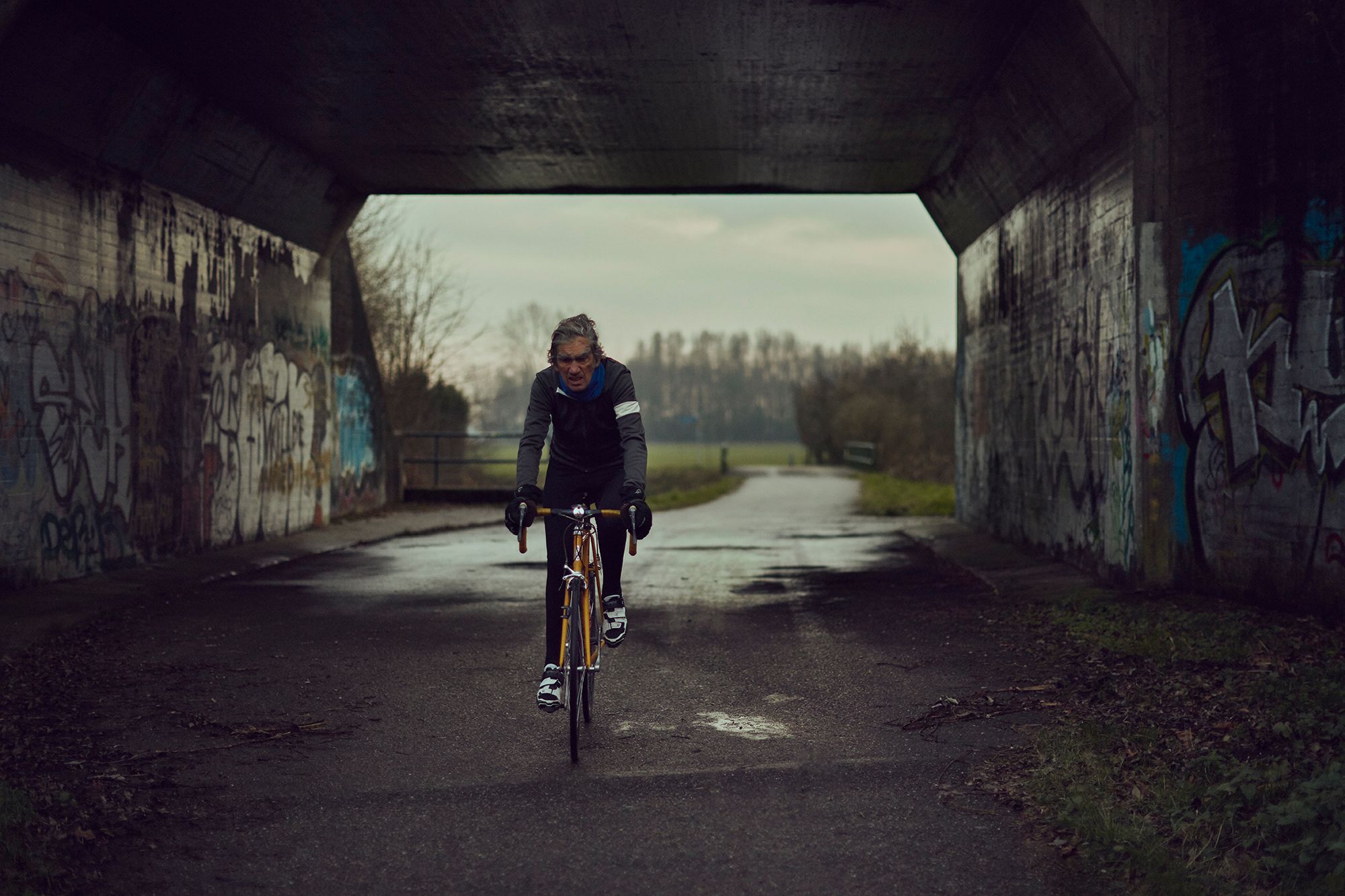 Albert riding beneath a concrete bridge