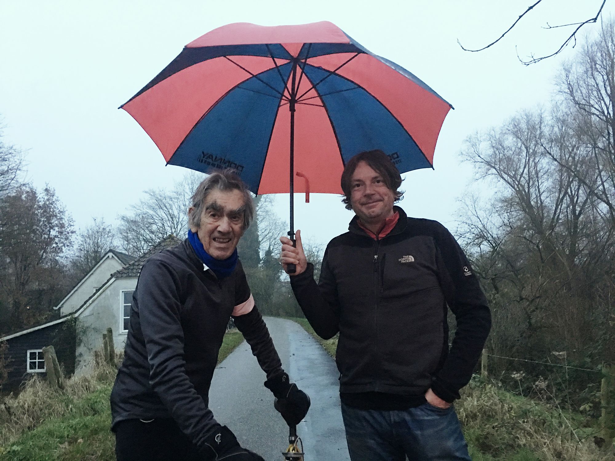 Albert and Dan Mawdesley beneath an umbrella