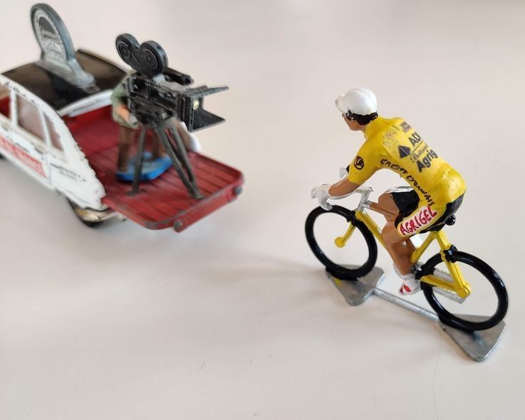 Miniature AG2R cyclist in front of a camera car