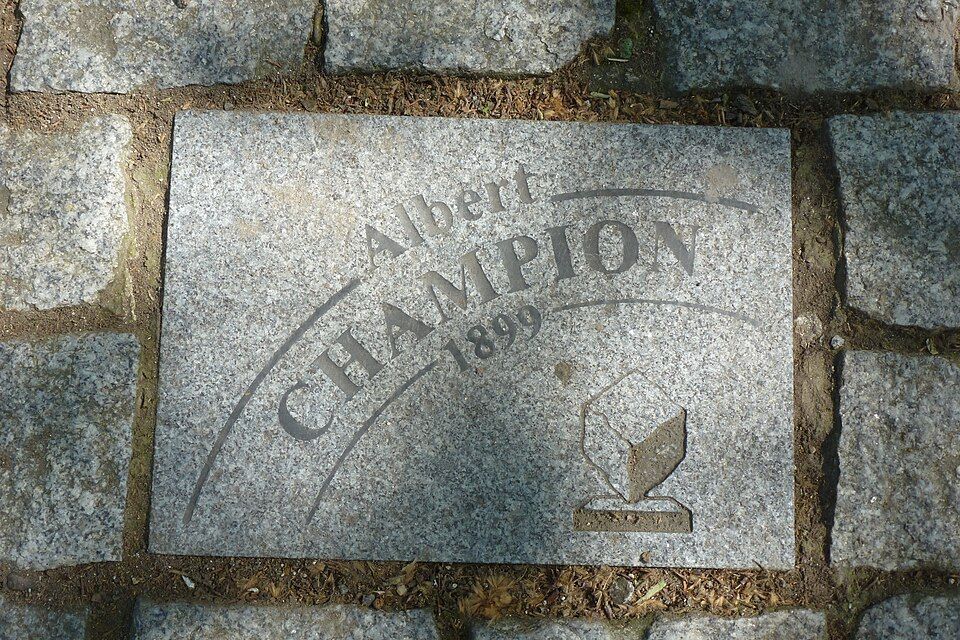 Cobblestone in Roubaix bearing the name Albert Champion and the year 1899