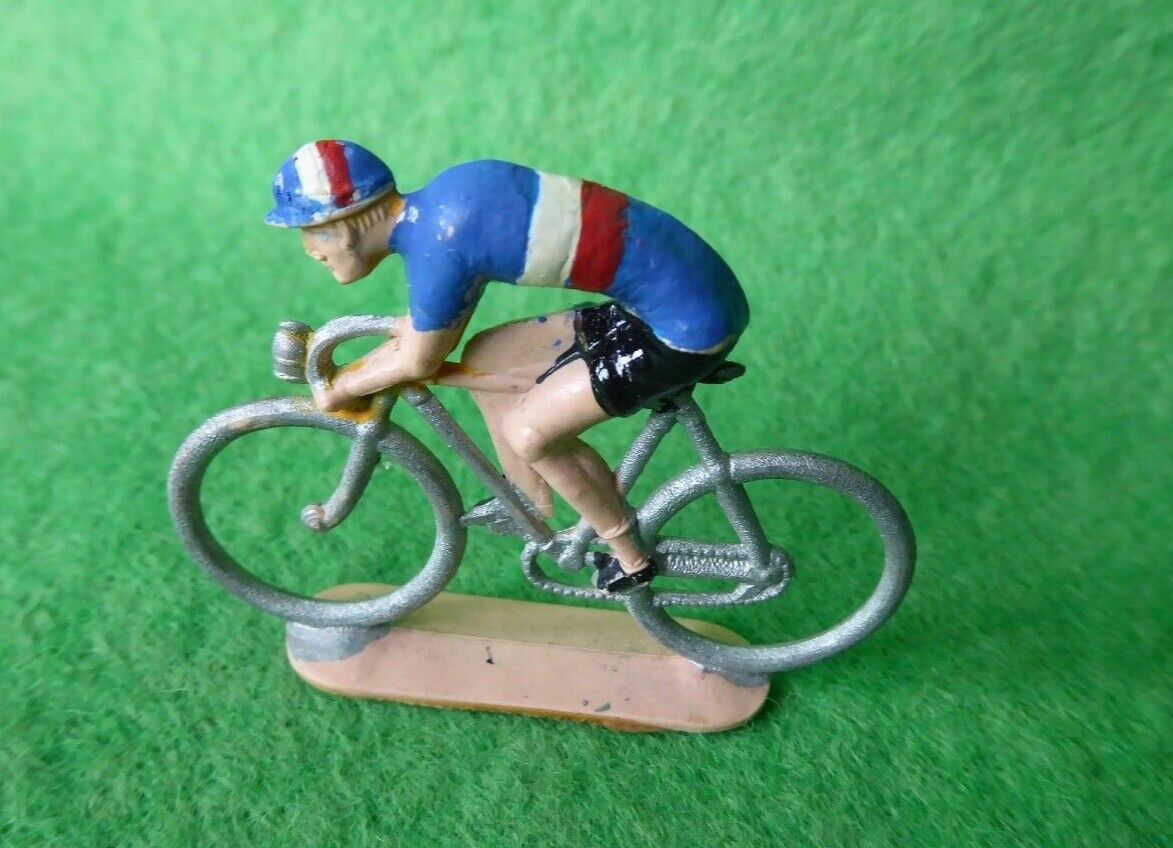 Miniature cyclist in French colours riding in a low position