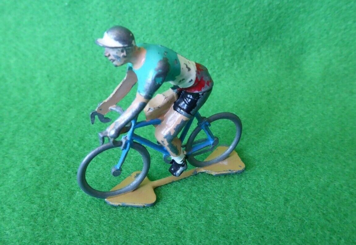 Worn hand-painted miniature cyclist on a blue bicycle