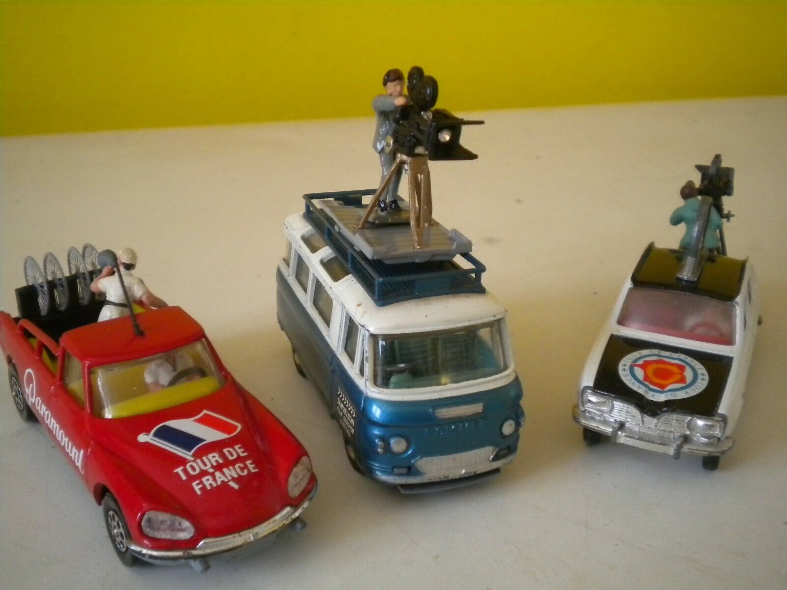Three miniature press and camera cars from bicycle races