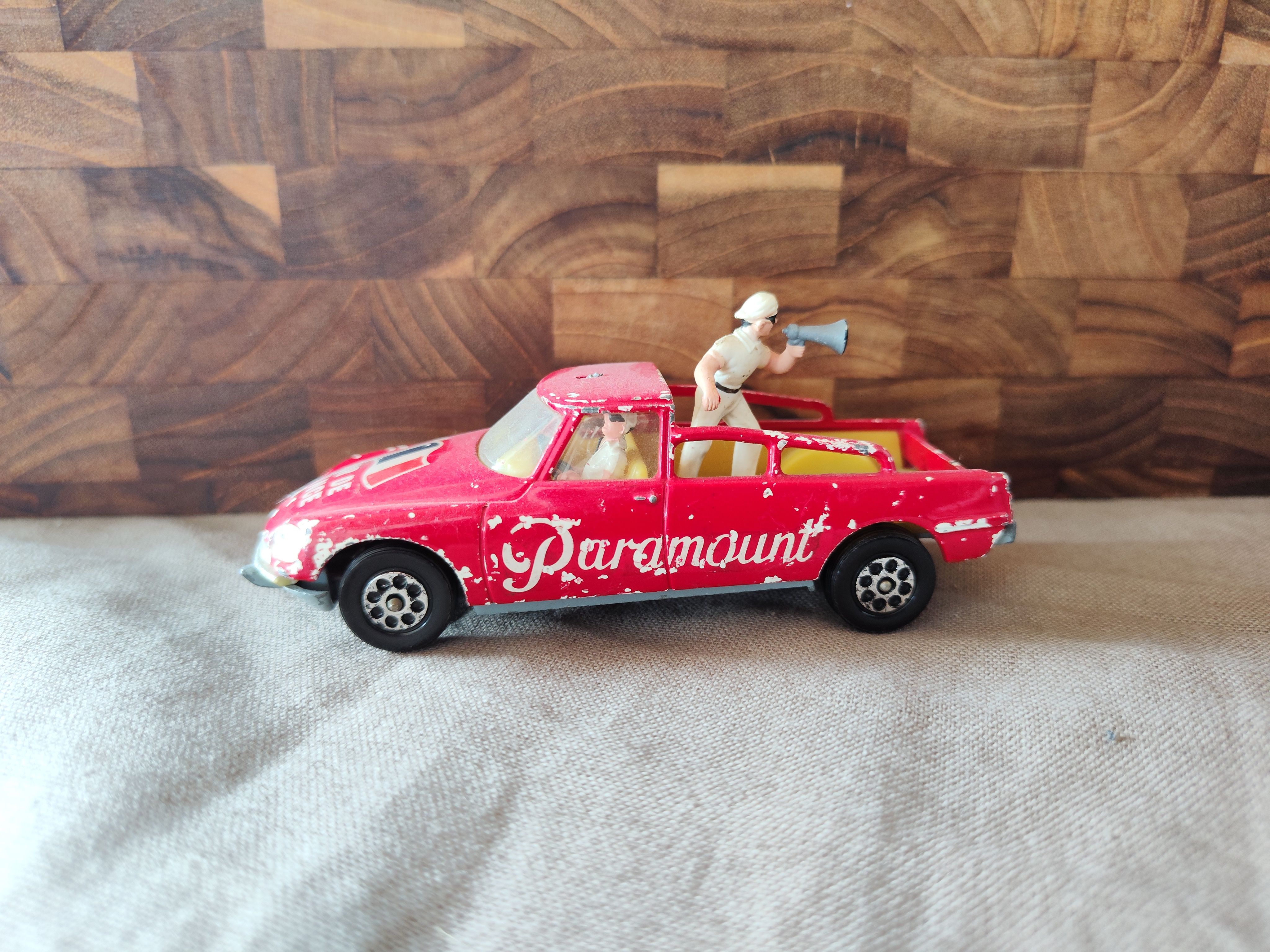 Red Paramount miniature car with an official and megaphone