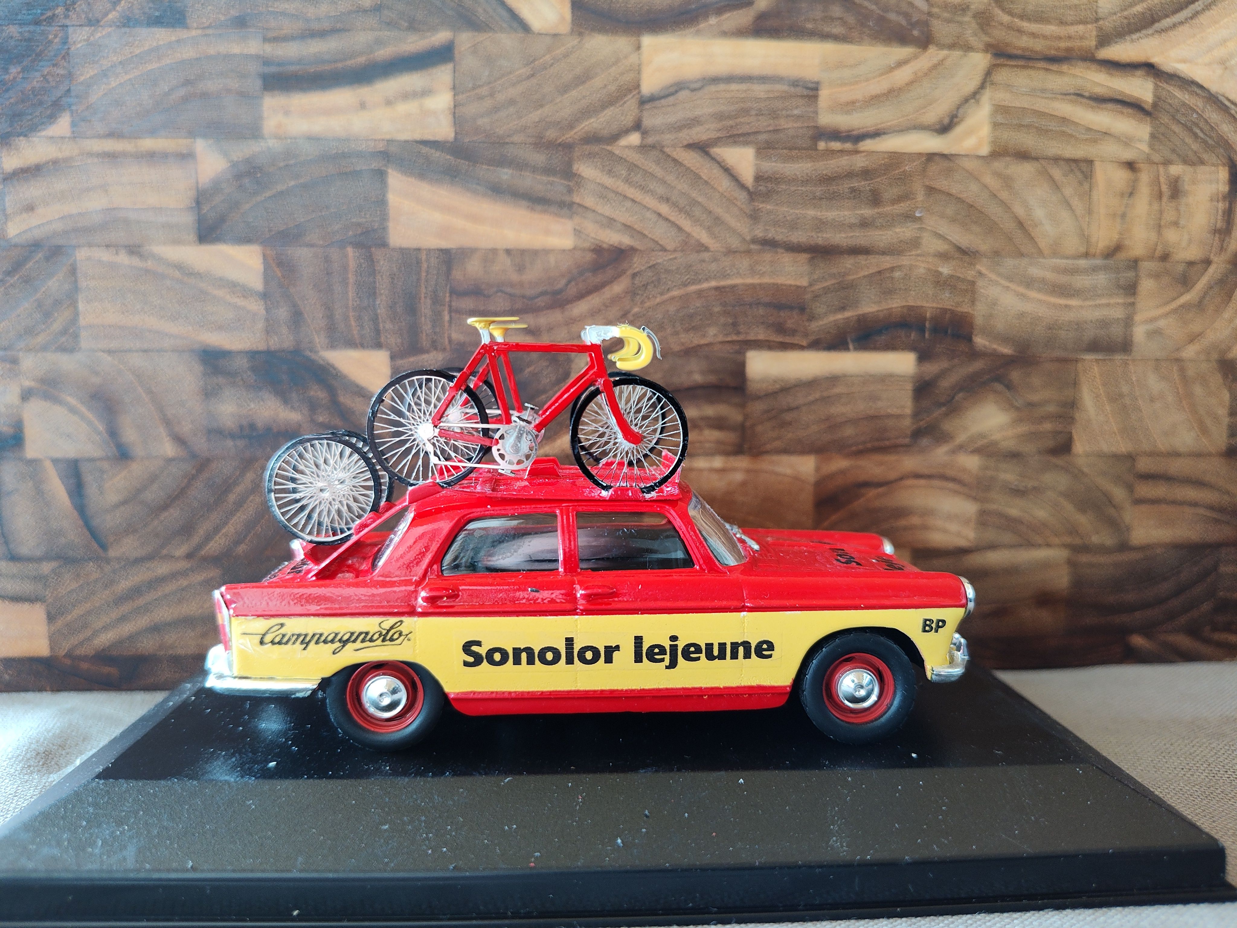 Red and yellow Sonolor Lejeune miniature service car with bicycles on the roof