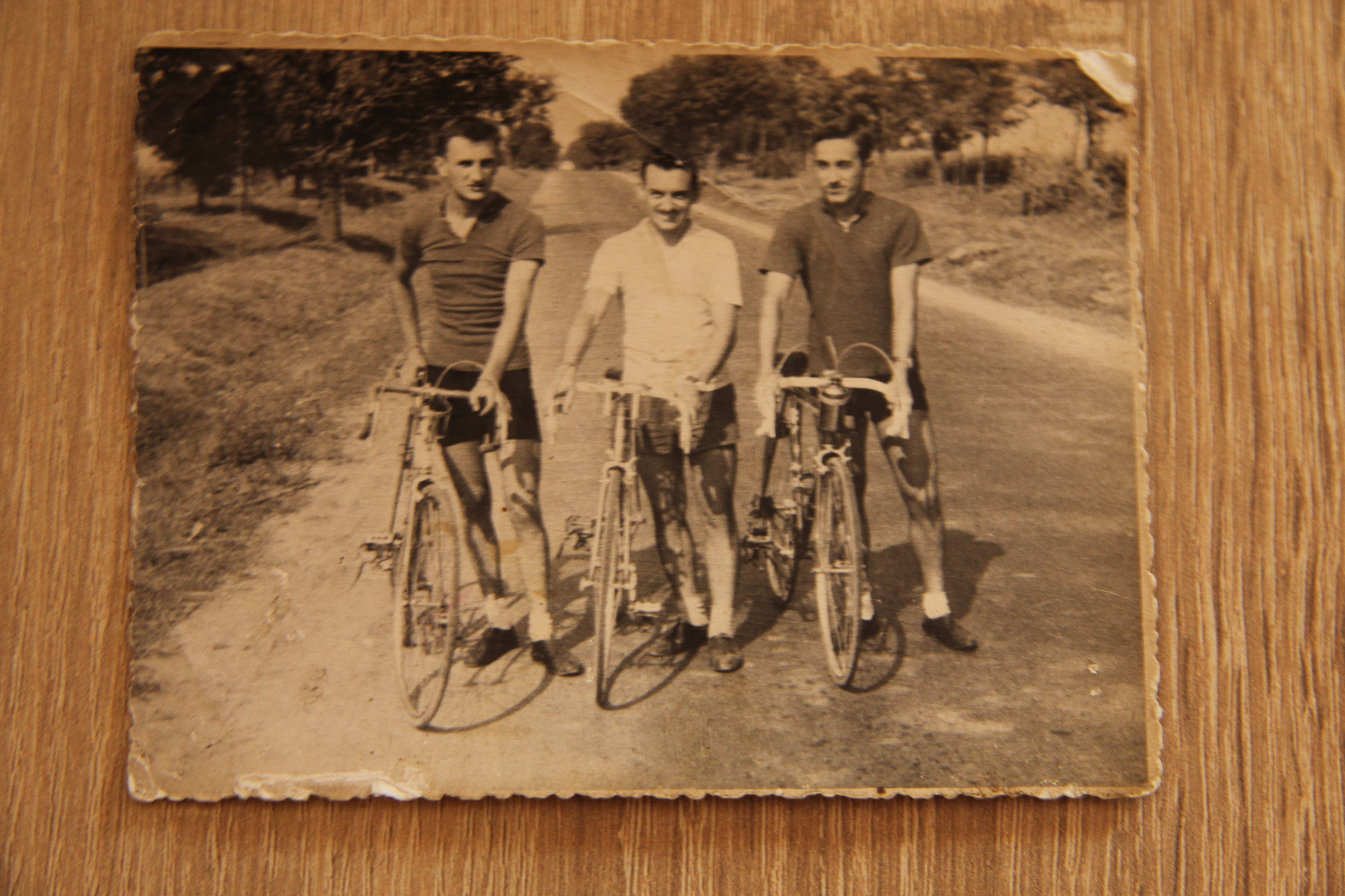 Three young men with racing bicycles in an old black-and-white photograph