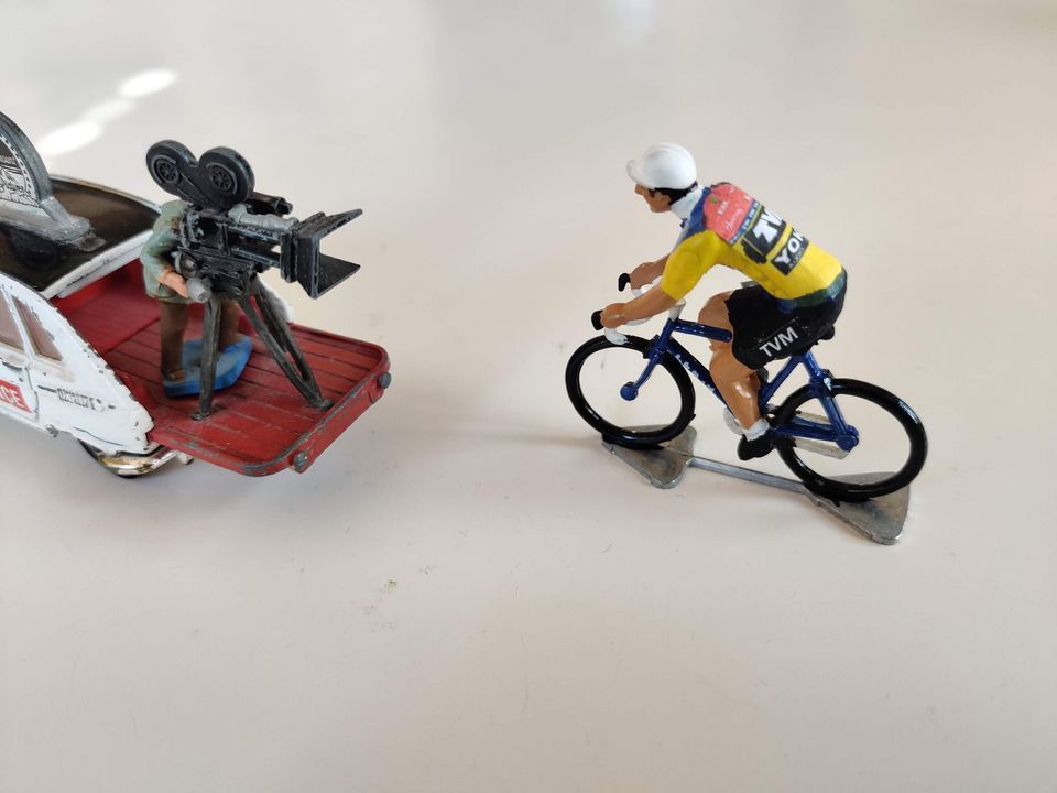 Miniature TVM cyclist in front of a camera car