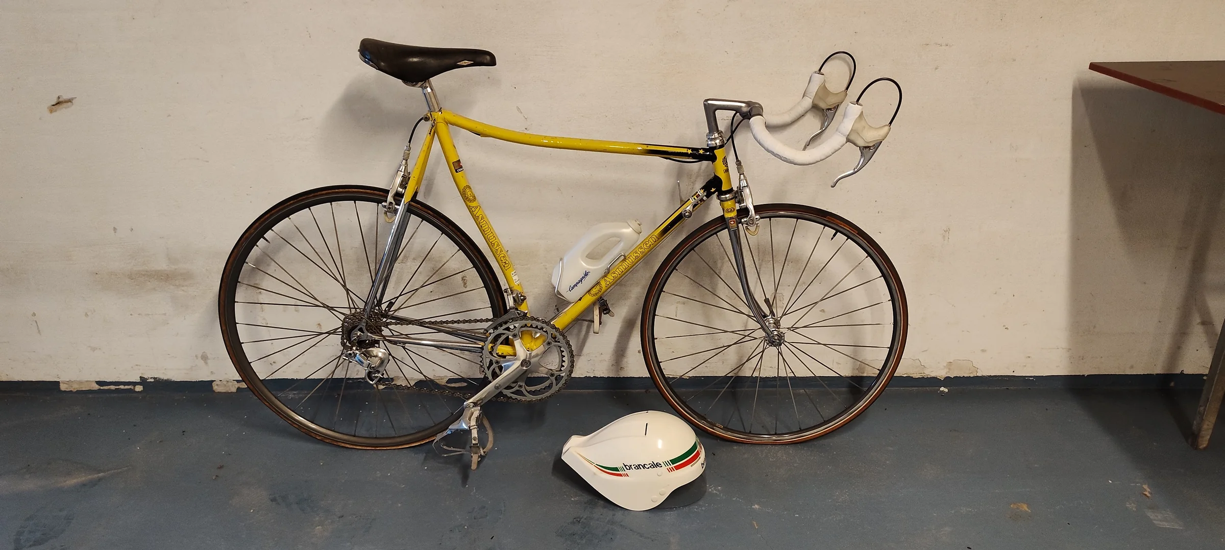 Yellow and black Asmussen Super Prestige time-trial bicycle with a small front wheel and large rear wheel