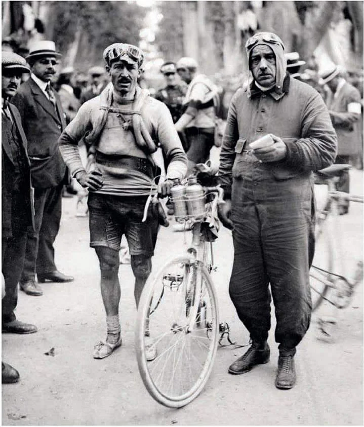 Jean Rossius and a helper beside a racing bicycle during the 1920 Tour de France